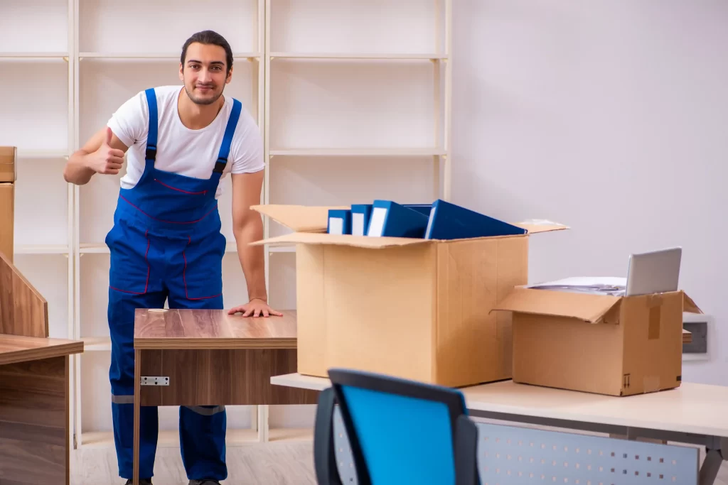 Young and skilled movers packing household items with care.